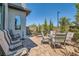 Charming patio features brick pavers, outdoor seating, and manicured landscaping at 3194 Lumassina Way, Henderson, NV 89044