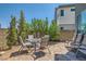 Charming brick patio featuring outdoor dining set, landscaping, and privacy wall at 3194 Lumassina Way, Henderson, NV 89044