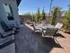 Inviting outdoor patio with brick pavers, various chairs, and a table for entertaining guests at 3194 Lumassina Way, Henderson, NV 89044