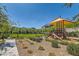 Community playground features modern equipment and lush landscaping for Gathering fun at 3194 Lumassina Way, Henderson, NV 89044