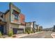 A row of modern two-story homes along a street, each with unique color accents and well-kept front yards at 3194 Lumassina Way, Henderson, NV 89044