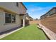 Backyard featuring a covered patio and artificial turf at 348 Andy Wheeler Dr, Henderson, NV 89011