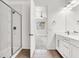 Updated bathroom featuring a walk-in shower, tiled floor, modern cabinets, and neutral paint at 348 Andy Wheeler Dr, Henderson, NV 89011