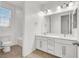 Modern bathroom with double vanity, neutral tile flooring, shower/tub combo, and natural light at 348 Andy Wheeler Dr, Henderson, NV 89011