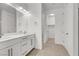 Bright bathroom featuring double sinks, modern cabinets, tiled floors, and updated fixtures at 348 Andy Wheeler Dr, Henderson, NV 89011