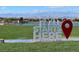 Scenic view of a community with a sign that reads 'It all starts here' near a lake and a city skyline backdrop at 348 Andy Wheeler Dr, Henderson, NV 89011