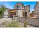 Charming home showcasing a desert landscape, two-car garage, and tile roof with exterior wall at 348 Andy Wheeler Dr, Henderson, NV 89011
