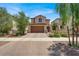 Charming two-story home showcasing a desert landscaped front yard and two-car garage, with a tile roof at 348 Andy Wheeler Dr, Henderson, NV 89011