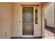 Modern front door with sleek hardware and sidelight, complemented by a neutral exterior at 348 Andy Wheeler Dr, Henderson, NV 89011