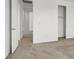 Hallway leads to the bedroom and closet, featuring a neutral color scheme, and door to the left at 348 Andy Wheeler Dr, Henderson, NV 89011