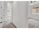 Hallway leads to the bedroom, featuring a neutral color scheme, and door to the right at 348 Andy Wheeler Dr, Henderson, NV 89011