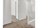 Bright hallway featuring neutral carpet, white walls, and multiple doorways, offering a clean and spacious feel at 348 Andy Wheeler Dr, Henderson, NV 89011