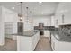 Modern kitchen features granite countertops, mosaic backsplash, and stainless steel appliances at 348 Andy Wheeler Dr, Henderson, NV 89011