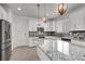 Stylish kitchen with stainless steel appliances, granite countertops, and globe pendant lighting at 348 Andy Wheeler Dr, Henderson, NV 89011