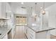 Open-concept kitchen with island and modern appliances seamlessly flowing into living area at 348 Andy Wheeler Dr, Henderson, NV 89011