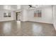 Spacious living room with tile flooring, ceiling fan, and sliding glass door to outdoor area at 348 Andy Wheeler Dr, Henderson, NV 89011