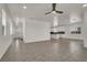 Bright open living area with tile floors, ceiling fan, and view of the kitchen at 348 Andy Wheeler Dr, Henderson, NV 89011
