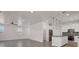 Open-concept living space with tile flooring seamlessly connects to the kitchen area at 348 Andy Wheeler Dr, Henderson, NV 89011