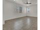 Spacious living room features tile flooring and natural light from multiple windows at 348 Andy Wheeler Dr, Henderson, NV 89011