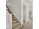 Carpeted staircase with white railings and a glimpse of a half-bathroom at 348 Andy Wheeler Dr, Henderson, NV 89011
