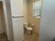 Neutral bathroom featuring a toilet, a window and neutral tile flooring at 4104 Free Bird Crest Ave, North Las Vegas, NV 89081