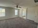 Bedroom featuring carpet flooring, three windows and access to the bathroom at 4104 Free Bird Crest Ave, North Las Vegas, NV 89081