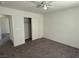 Neutral bedroom with carpet, ceiling fan and a door to the hallway at 4104 Free Bird Crest Ave, North Las Vegas, NV 89081