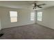 Bedroom featuring carpet flooring, three windows, and a ceiling fan at 4104 Free Bird Crest Ave, North Las Vegas, NV 89081