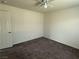 Neutral bedroom with carpet, ceiling fan and a door to the hallway at 4104 Free Bird Crest Ave, North Las Vegas, NV 89081