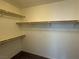 Spacious walk-in closet with carpet, shelving and rods for hanging clothes at 4104 Free Bird Crest Ave, North Las Vegas, NV 89081
