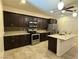 Modern kitchen with stainless steel appliances, center island, and dark wood cabinets at 4104 Free Bird Crest Ave, North Las Vegas, NV 89081