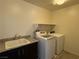 Laundry room featuring a utility sink, granite counters, a washer and dryer at 4104 Free Bird Crest Ave, North Las Vegas, NV 89081