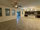 An open concept floorplan showcasing a living room and kitchen with modern appliances and tiled floors at 4104 Free Bird Crest Ave, North Las Vegas, NV 89081