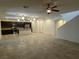 Spacious living room and kitchen with stainless steel appliances under recessed lighting and ceiling fans at 4104 Free Bird Crest Ave, North Las Vegas, NV 89081