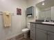 Bathroom featuring granite countertops, gray cabinetry, decorative art and a framed mirror at 4273 Venus Falls Ave, North Las Vegas, NV 89084
