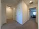 Bright hallway featuring carpeted floors, a double door closet, and entryways into bedrooms and bathrooms at 4273 Venus Falls Ave, North Las Vegas, NV 89084