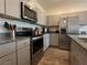 Well-equipped kitchen featuring stainless steel appliances and gray cabinetry at 4273 Venus Falls Ave, North Las Vegas, NV 89084
