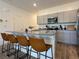 Modern kitchen with stainless steel appliances, gray cabinets, and granite countertops at 4273 Venus Falls Ave, North Las Vegas, NV 89084