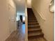 View of carpeted stairs leading to the upper level, with an open floor plan visible in the background at 4273 Venus Falls Ave, North Las Vegas, NV 89084
