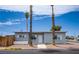 Charming single-story home featuring a manicured yard and a welcoming entrance with beautiful palm trees at 4831 Vermont Ave, Las Vegas, NV 89107