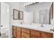 Bathroom with double sink vanity, wood cabinets, and well-lit mirror at 5155 W Tropicana Ave # 2017, Las Vegas, NV 89103