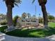 The West Trop Condos community sign surrounded by palm trees and lush landscaping on a sunny day at 5155 W Tropicana Ave # 2017, Las Vegas, NV 89103