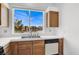 Bright kitchen features a large window above the dual sink and a white tiled countertop at 5155 W Tropicana Ave # 2017, Las Vegas, NV 89103