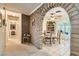 Hallway with brick archway leading to an open-concept living and dining area at 5368 Regal Ave, Las Vegas, NV 89146