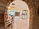 Open-concept living area with brick archway, dining table, and view of the living room and kitchen at 5368 Regal Ave, Las Vegas, NV 89146