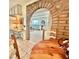 View from the dining area through a brick archway into a bright and comfortable living room at 5368 Regal Ave, Las Vegas, NV 89146