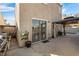 Home exterior with a patio, barbecue, gazebo and partially obscured swimming pool at 5458 Walton Heath Ave, Las Vegas, NV 89142