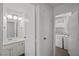 Clean bathroom with a single vanity and adjoining laundry room featuring a washer and dryer at 5458 Walton Heath Ave, Las Vegas, NV 89142