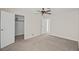 Comfortable bedroom features an open closet with a ceiling fan and carpeted flooring at 5458 Walton Heath Ave, Las Vegas, NV 89142