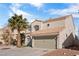 Two-story home featuring a two-car garage, desert landscaping and tiled roof at 5458 Walton Heath Ave, Las Vegas, NV 89142